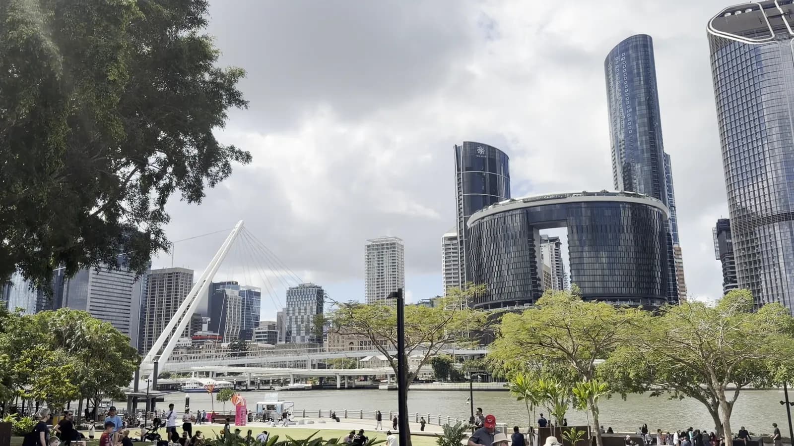 The Brisbane CBD skyline across the river from the South Bank parklands on a bright day