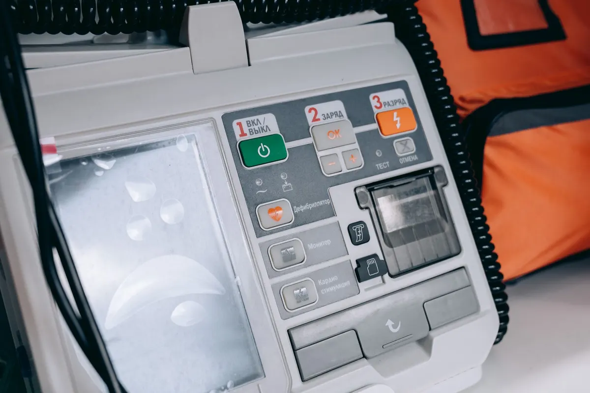A defibrillator, its controls and paddles ready on the unit