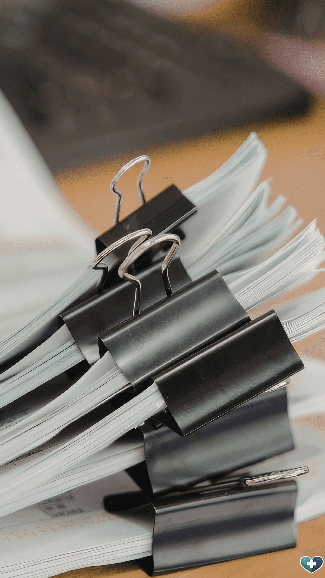 Paperwork and documents on a desk — free resources for GPs and clinic managers