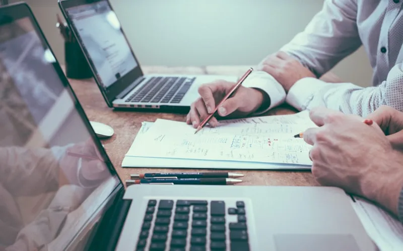 A practice manager working through credentialing paperwork at a desk